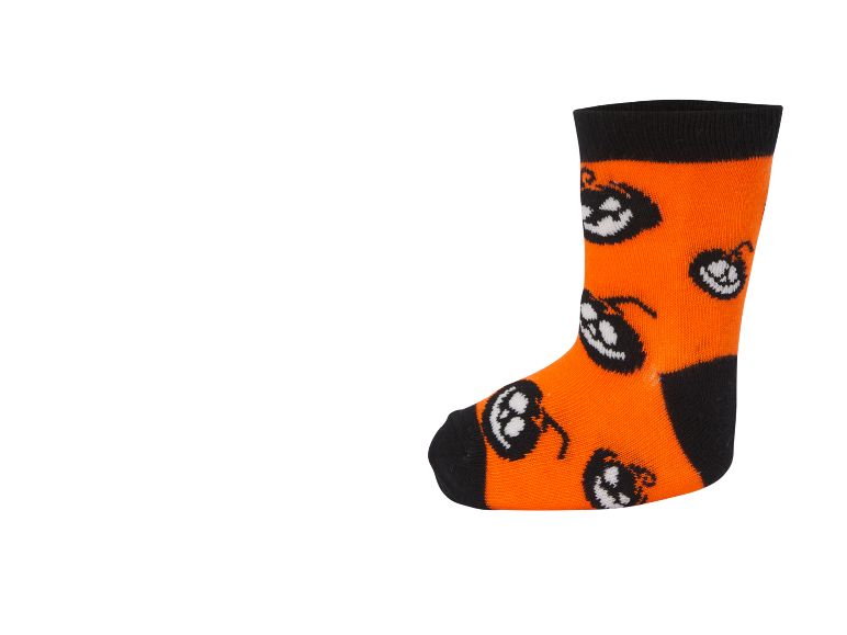 Πορτοκαλί κάλτσα Halloween με μαύρες μανσέτες και σχέδια λευκών κολοκυθών.