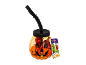Κολοκυθάκι Halloween με καλαμάκι, γεμάτο καραμέλες, και ένα πακέτο καραμελών με θέμα Halloween.