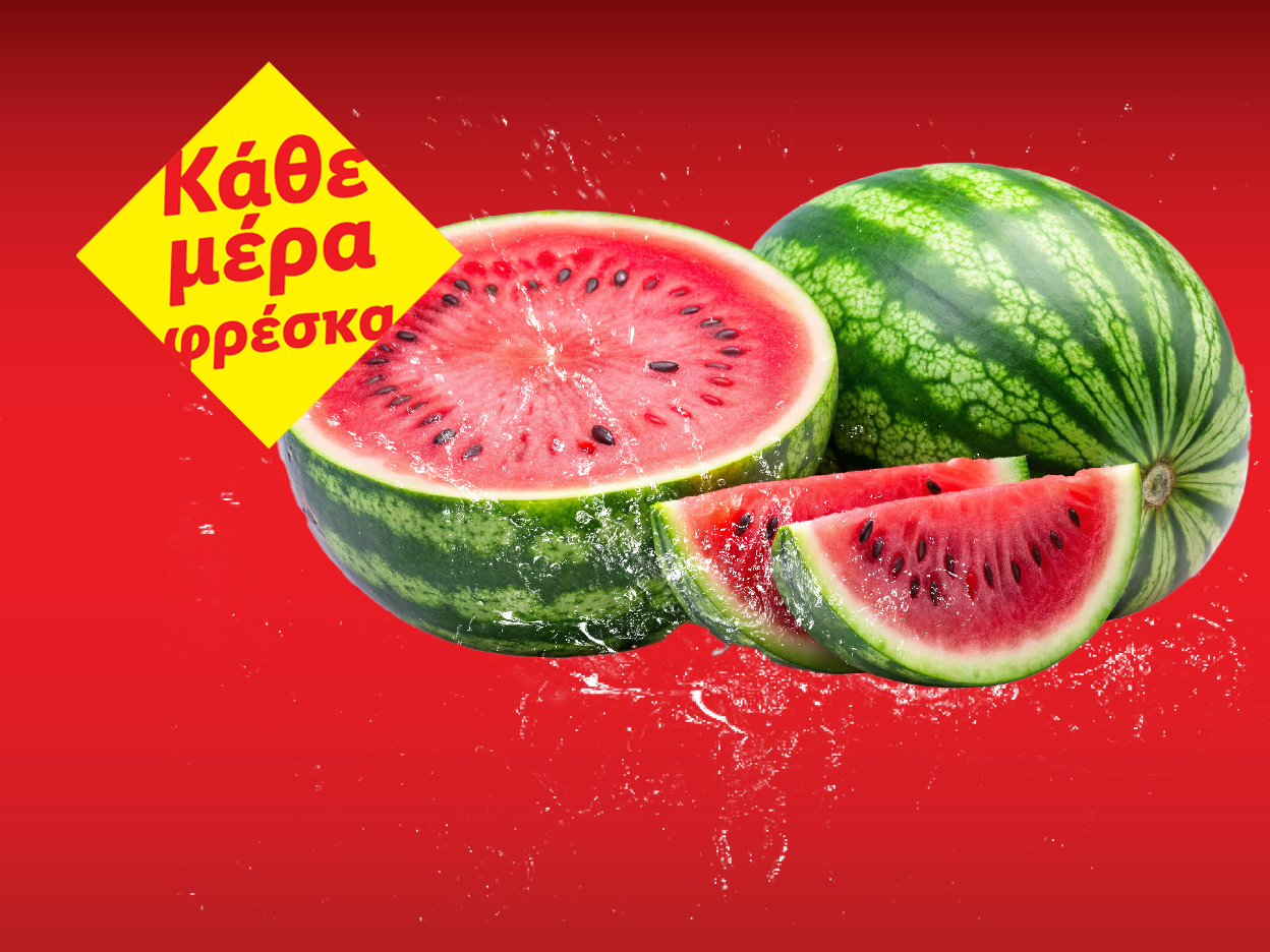 Καρπούζια με μια κίτρινη πινακίδα που γράφει «Κάθε μέρα φρέσκα».