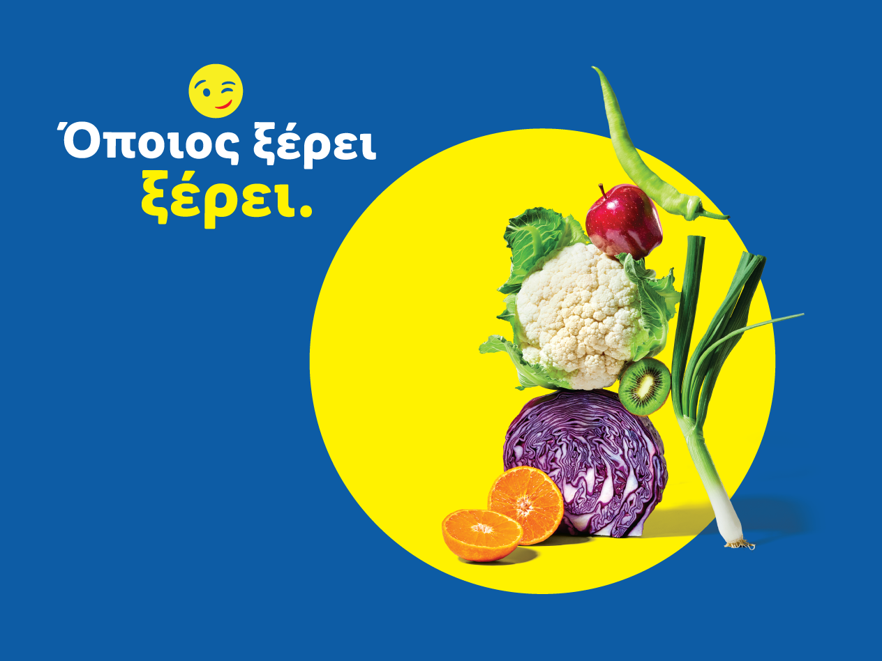 Φρέσκα φρούτα και λαχανικά, όπως κουνουπίδι, λάχανο, μήλο, ακτινίδιο, πορτοκάλι, πιπεριά και φρέσκο κρεμμυδάκι, με το μήνυμα «Όποιος ξέρει ξέρει».