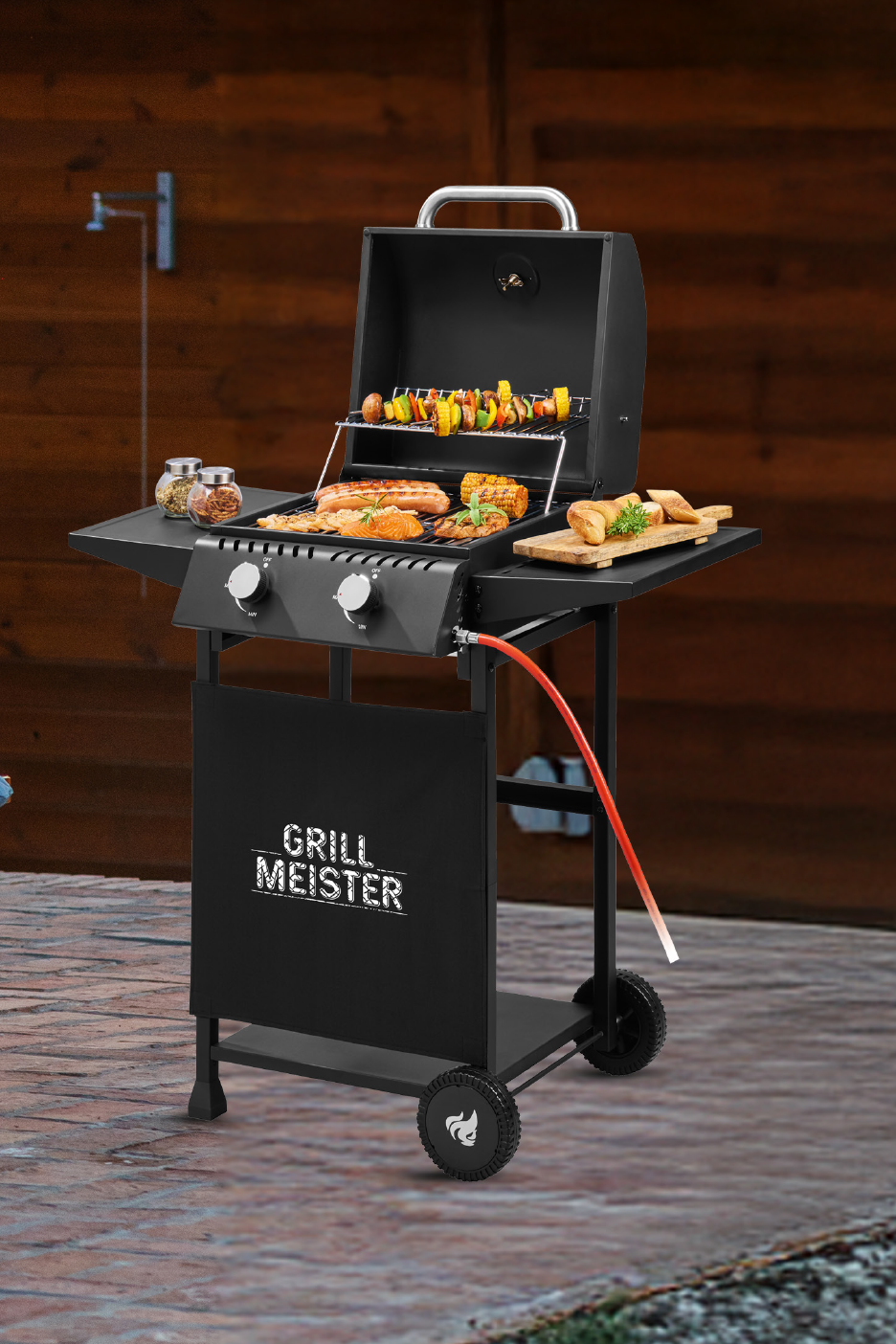 Μαύρη ψησταριά υγραερίου με φαγητό, μπαχαρικά και ψωμί, με την επιγραφή 'GRILL MEISTER'.